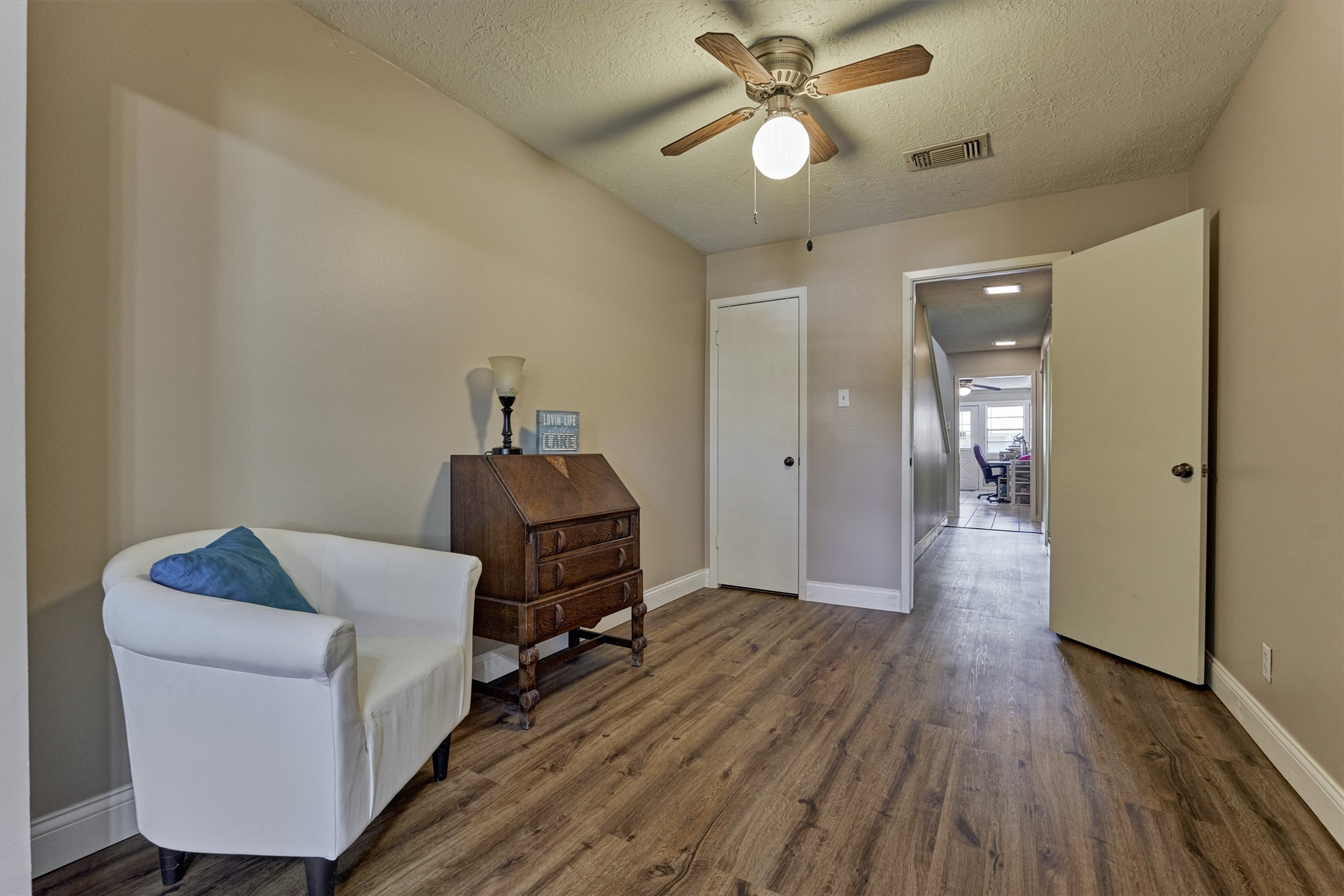 39 Regency Point Conroe, TX 77356 - Photo 9 of 44 a view of a livingroom with wooden floor and a ceiling fan