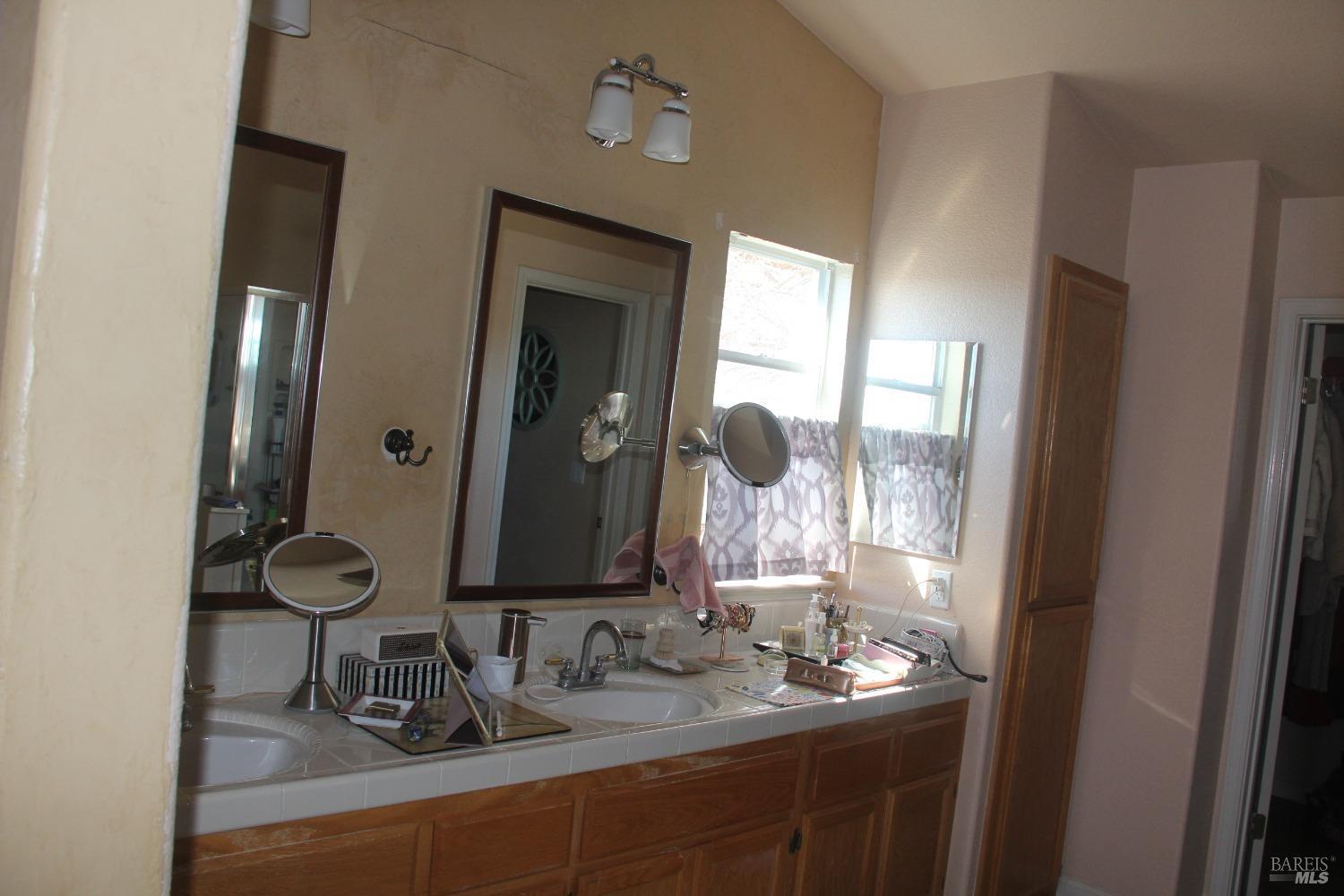 6461 Eagle Ridge Drive Vallejo, CA 94591 - Photo 18 of 22 a bathroom with a sink and a mirror