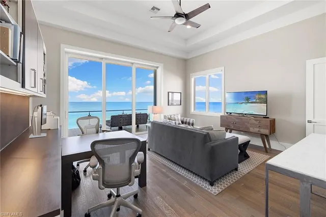 a view of a room with furniture and wooden floor