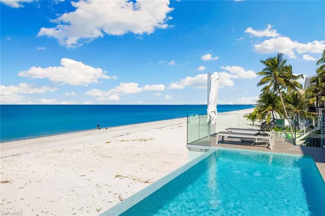 a view of a terrace with lawn chairs