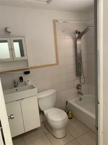 a bathroom with a toilet sink and shower