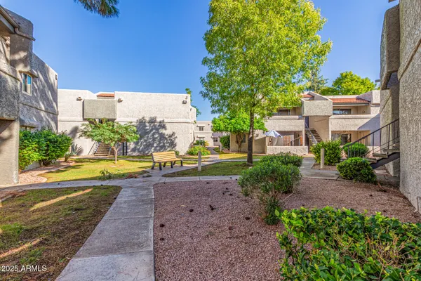a front view of a house with a yard and outdoor seating