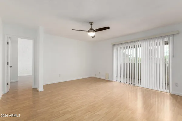 an empty room with fan and entryway