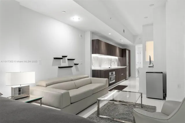 a living room with furniture a lamp and a flat screen tv