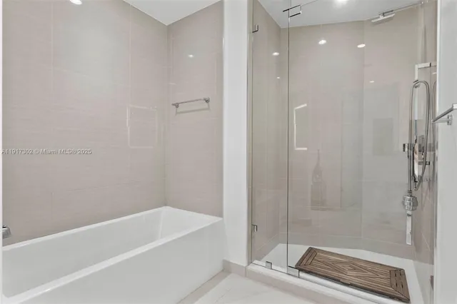 a bathroom with a bathtub and a shower
