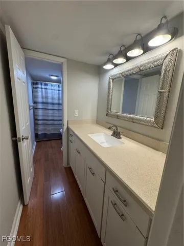 a bathroom with a double vanity sink and mirror