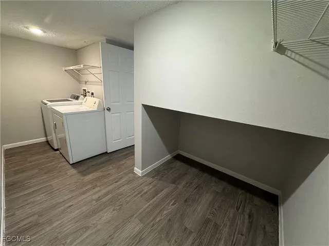 a room with a wooden floor and white doors