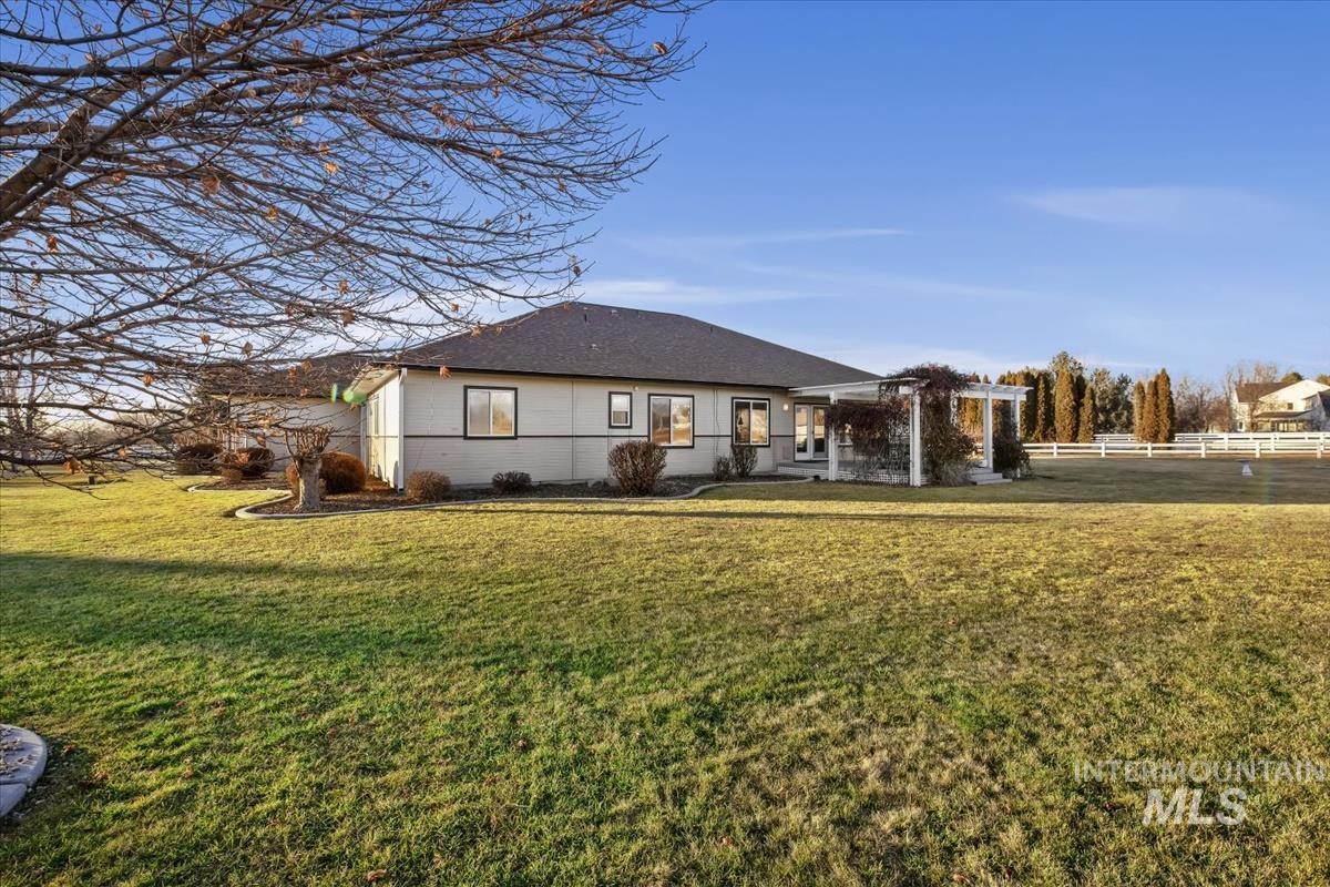 3366 North Croft Way Eagle, ID 83616 - Photo 5 of 33 Back of house featuring a shingled roof and concrete block siding