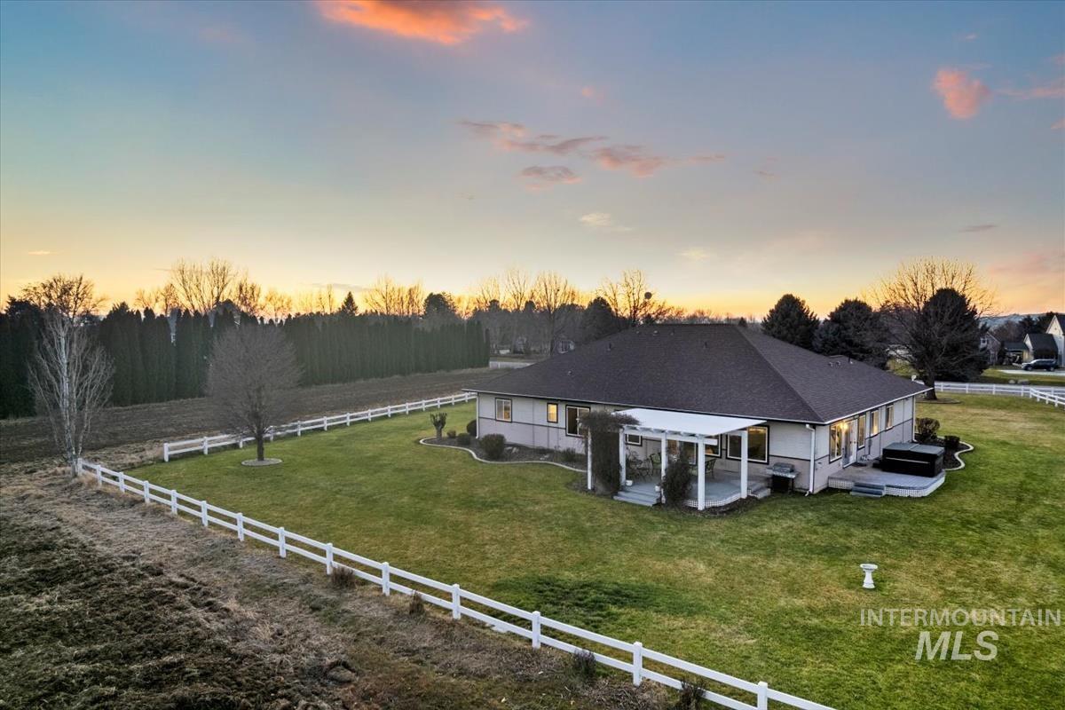 3366 North Croft Way Eagle, ID 83616 - Photo 8 of 33 Back of property at dusk featuring a patio and a fenced backyard