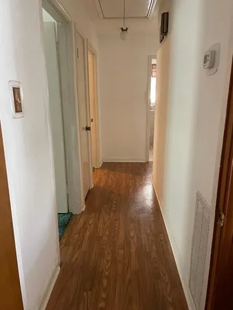a view of hallway with wooden floor