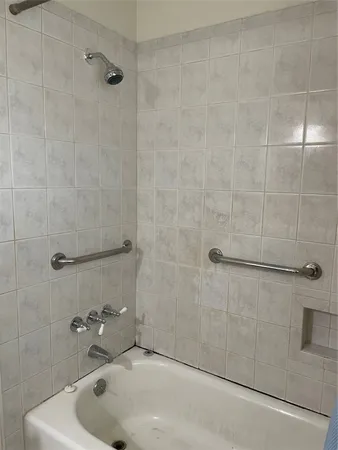 a bathroom with a tub and a shower