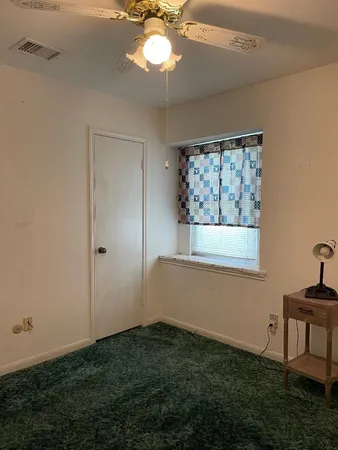 a view of room with window and ceiling fan