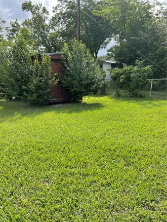 a view of a yard with a house in the background