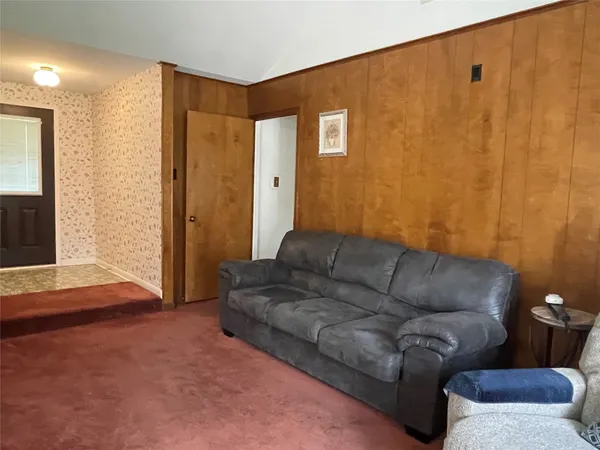 a living room with furniture and a rug