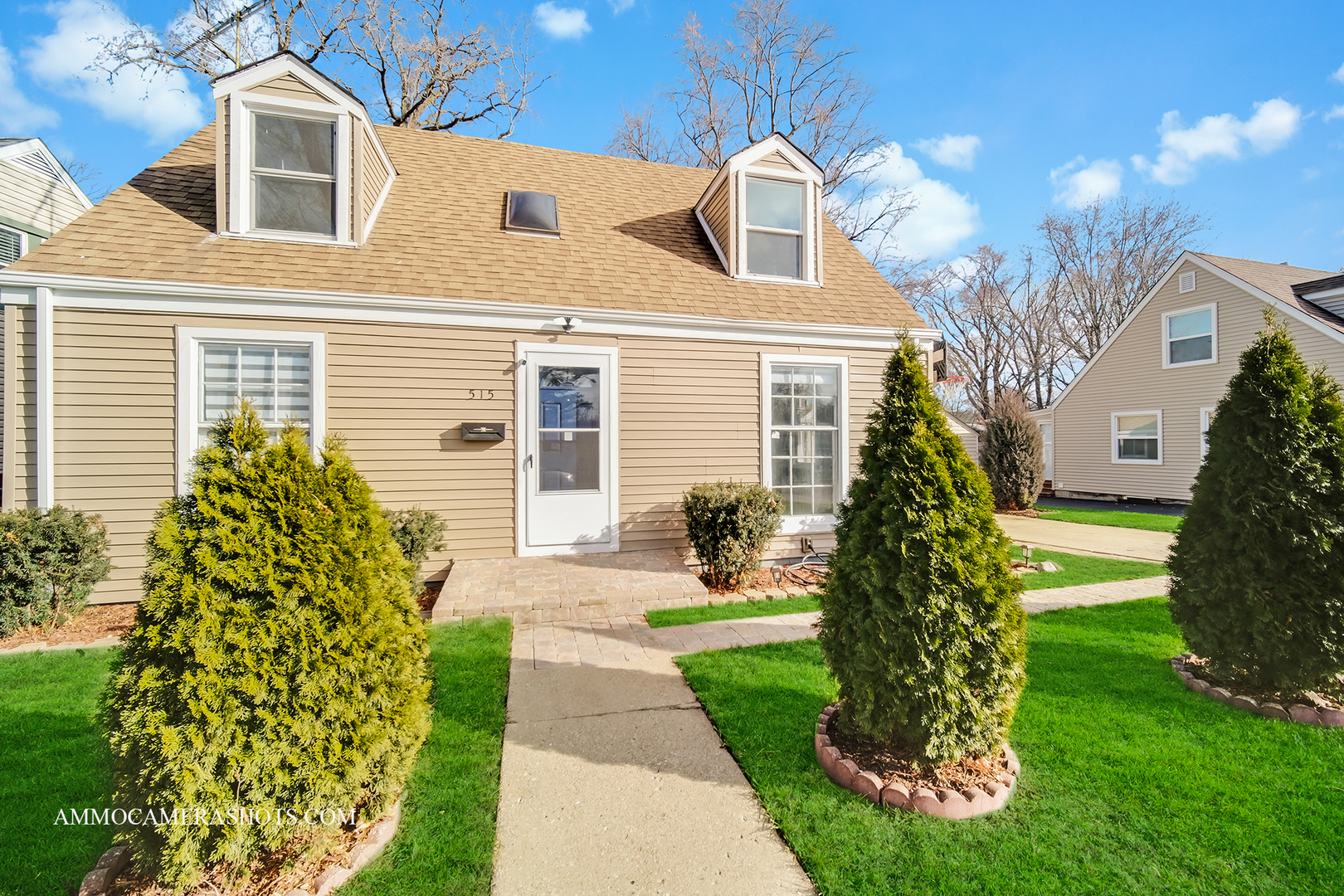 515 Miller Drive Elgin, IL 60123 - Photo 3 of 27 a front view of a house with a garden and plants
