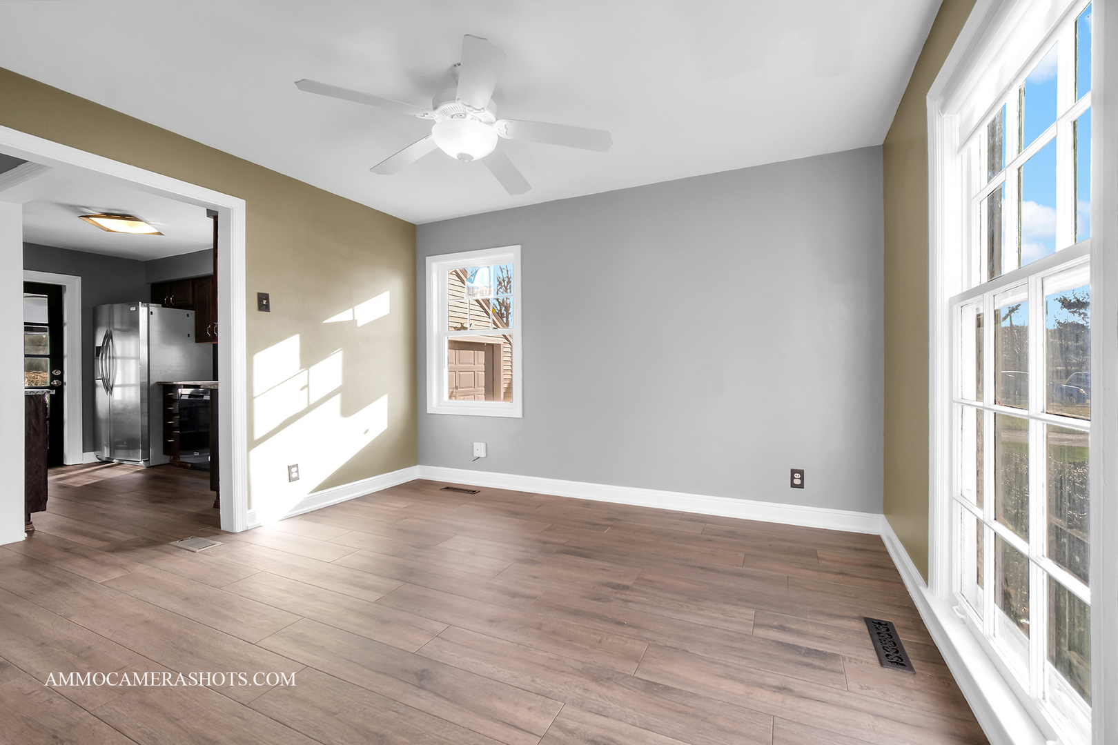 515 Miller Drive Elgin, IL 60123 - Photo 6 of 27 a view of an empty room with a window and wooden floor