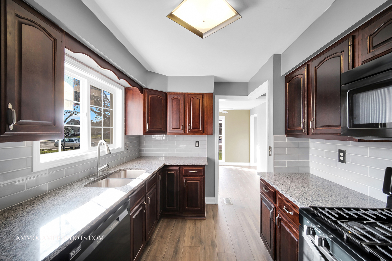 515 Miller Drive Elgin, IL 60123 - Photo 10 of 27 a kitchen with stainless steel appliances granite countertop a stove a sink and a microwave
