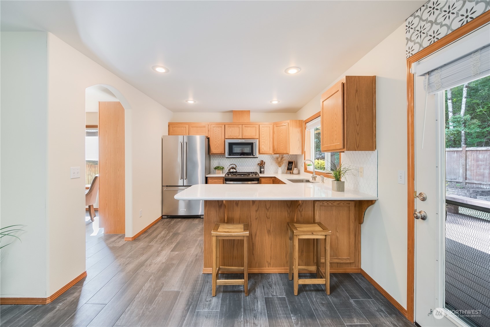 20014 34th Avenue Southeast Bothell, WA 98012 - Photo 8 of 22 a kitchen with kitchen island wooden cabinets and refrigerator