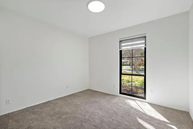 an empty room with windows and closet