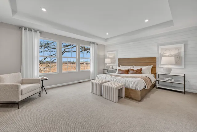 a bedroom with a bed and a couch with window