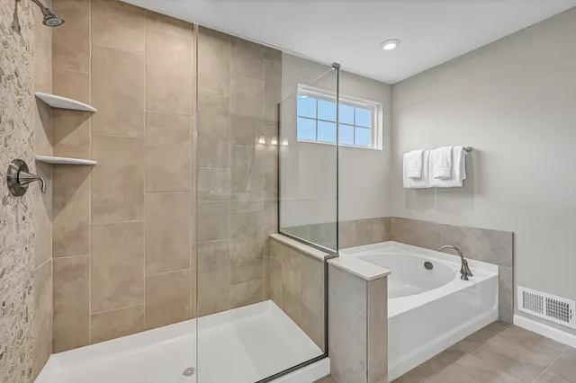 a bathroom with a bathtub and a shower