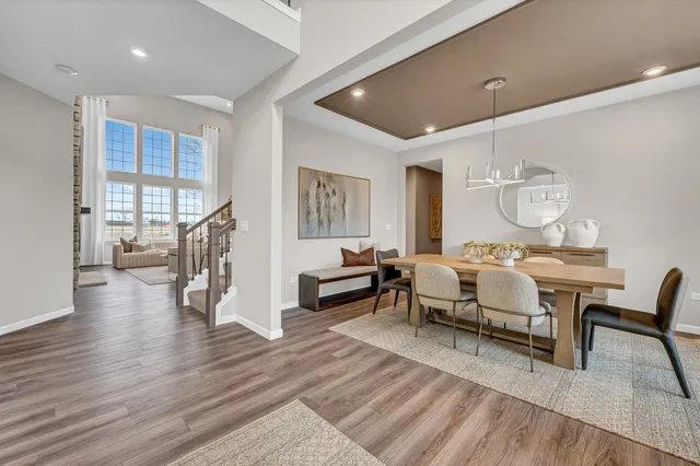 a living room with furniture a rug and a table