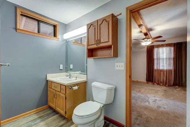 a view of a livingroom with a ceiling fan and window