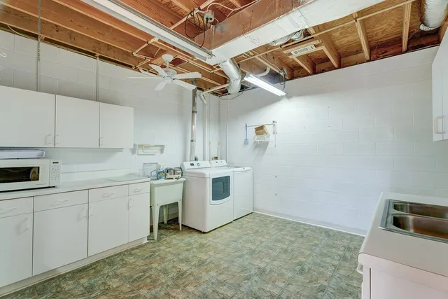 a kitchen with a sink and chairs