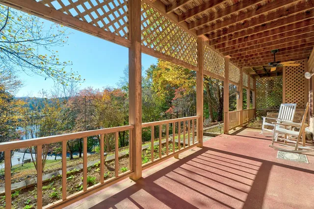 a view of balcony with wooden floor and fence