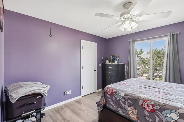 a bedroom with a bed dresser and a window