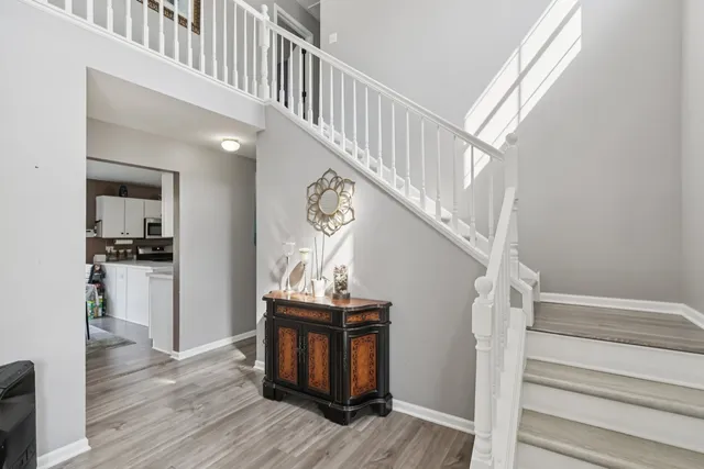 a view of entryway and hall with wooden floor