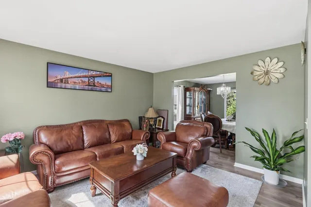 a living room with furniture a couch and a potted plant
