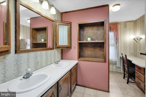 a bathroom with a sink a mirror and a shower