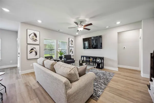 a living room with furniture and a large window