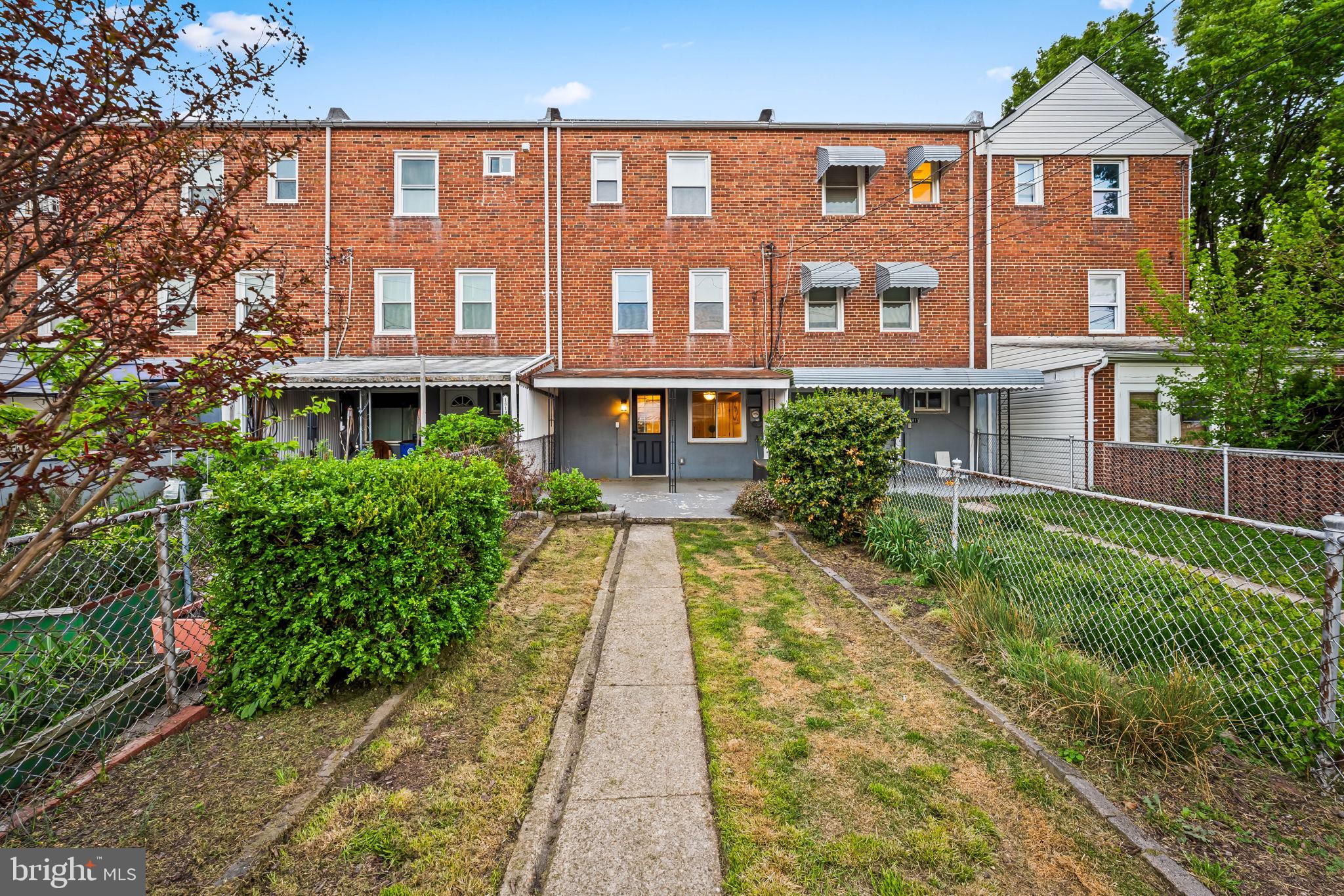 1817 Dunmere Road Baltimore, MD 21222 - Photo 25 of 27 a front view of a residential apartment building with a yard