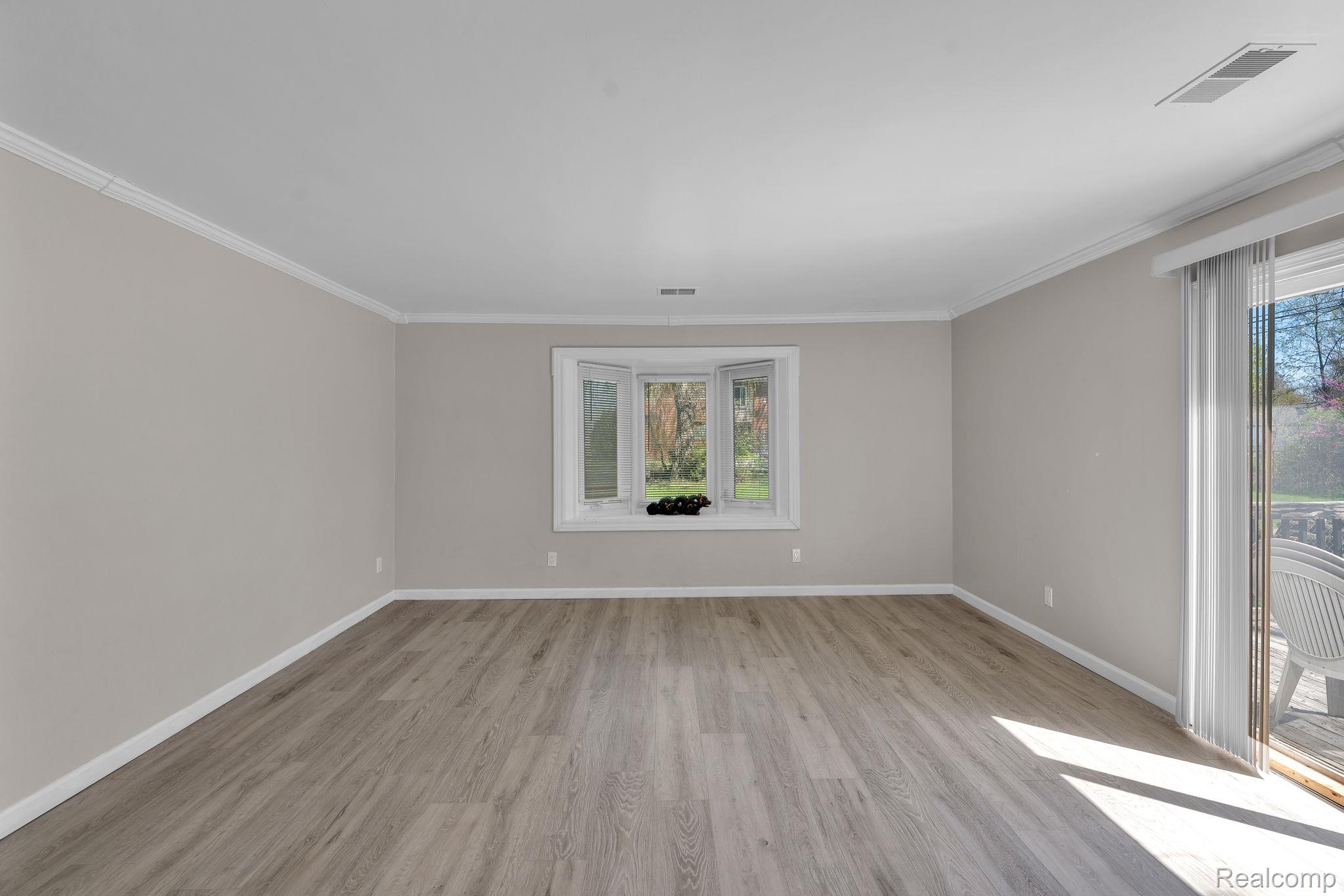 36845 Sibley Road New Boston, MI 48164 - Photo 15 of 22 Empty room featuring light wood finished floors and ornamental molding