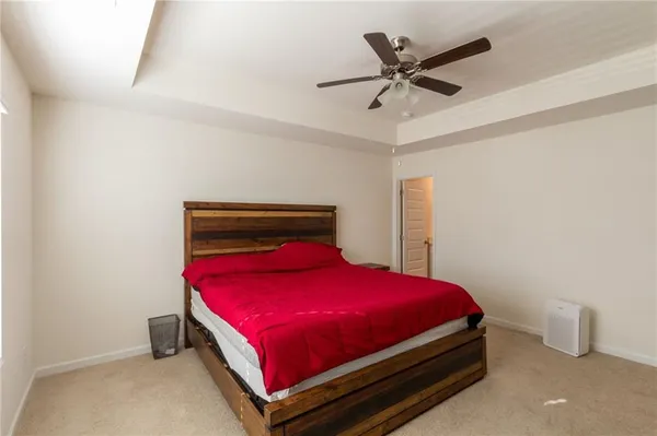 a bed sitting in a bedroom next to a window