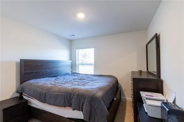 a bedroom with a bed and window