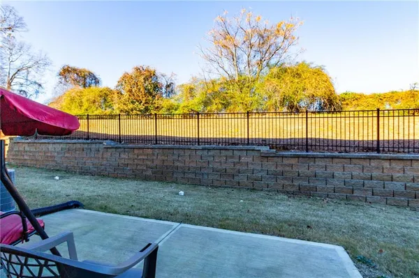 a view of a backyard with wooden fence