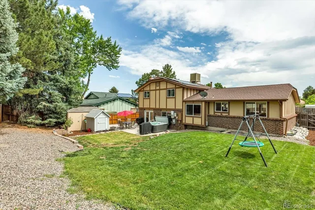 a view of a house with a yard and sitting area