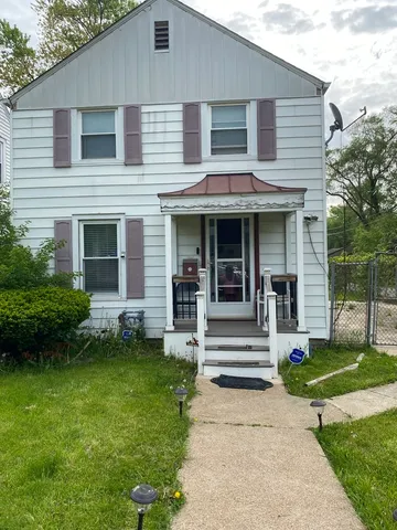 a front view of a house with a garden and plants