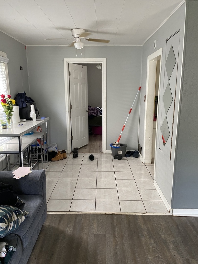 14735 Myrtle Avenue Harvey, IL 60426 - Photo 2 of 6 a view of a livingroom with furniture and gym equipment