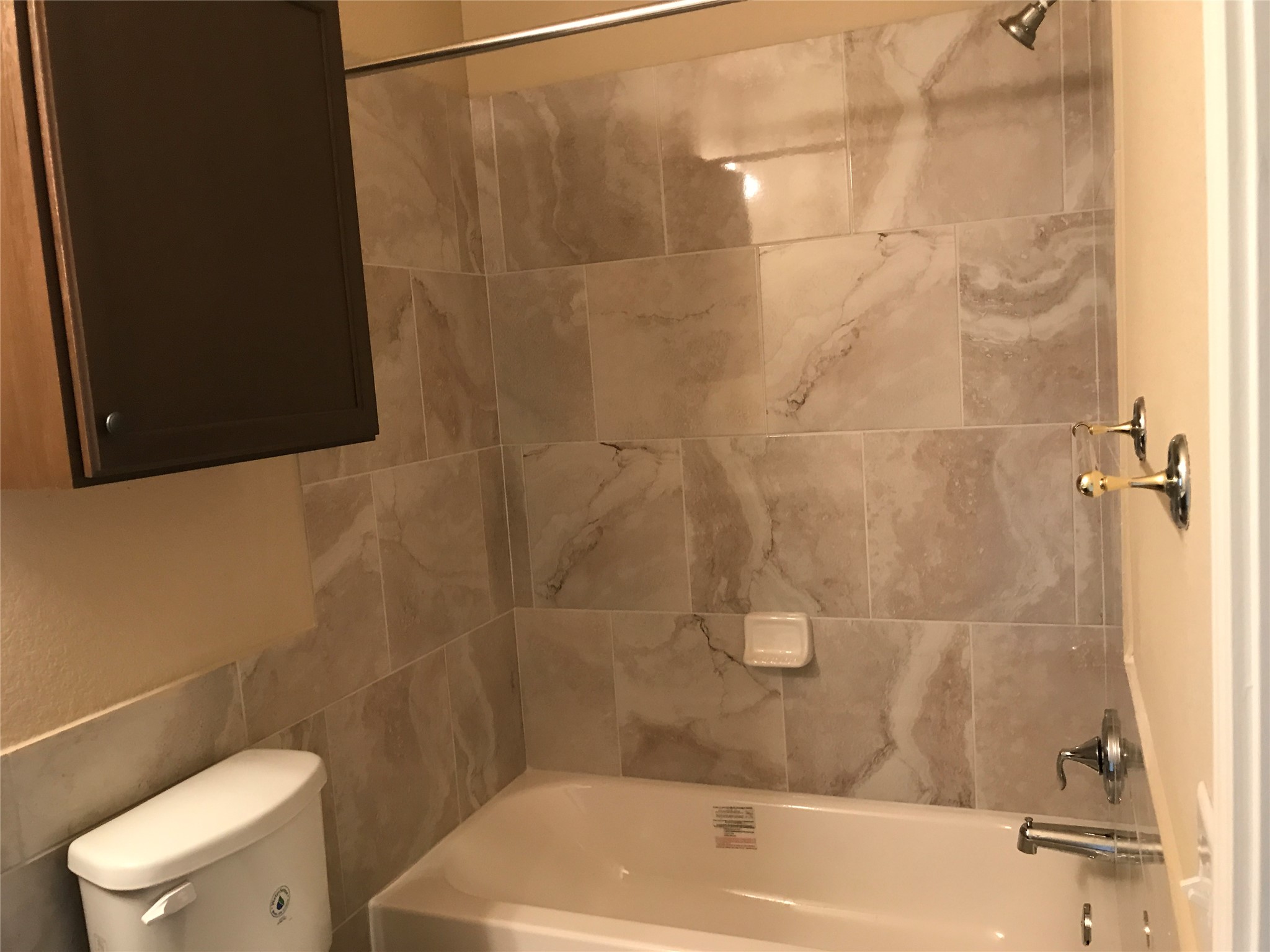 2507 Oak Lane, Unit A Georgetown, TX 78628 - Photo 11 of 11 A classic bath with tiled walls and an overhead shower head provides a refreshing escape.