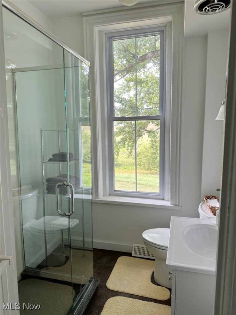 1241 Apollo Road Southeast Carrollton, OH 44615 - Photo 31 of 33 Bathroom with a shower with door, vanity, and toilet