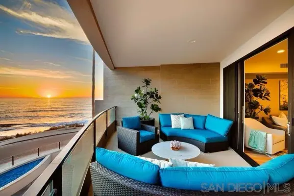 a living room with furniture and a ocean view