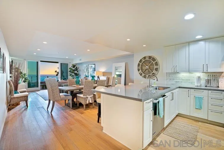 6767 Neptune Place, Unit 202 La Jolla, CA 92037 - Photo 16 of 27 a kitchen with stainless steel appliances granite countertop a stove and cabinets
