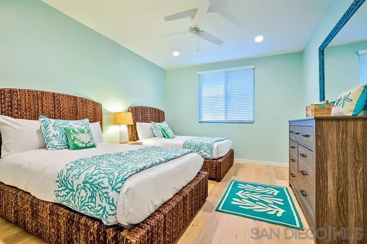 6767 Neptune Place, Unit 202 La Jolla, CA 92037 - Photo 20 of 27 a bedroom with a bed and wooden floor