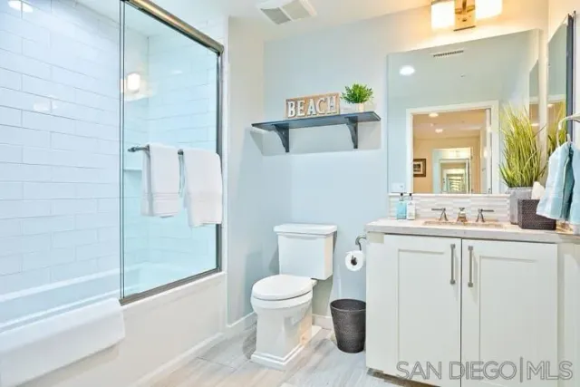 a bathroom with a toilet sink and a mirror