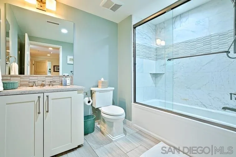 6767 Neptune Place, Unit 202 La Jolla, CA 92037 - Photo 26 of 27 a bathroom with a sink a toilet and shower