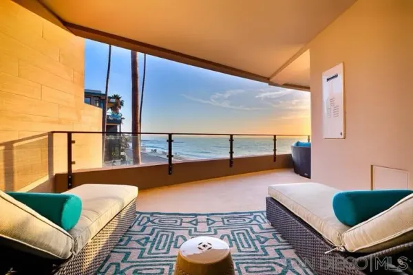 a balcony with chairs and with an outdoor view